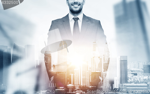 Image of close up of happy businessman over city background