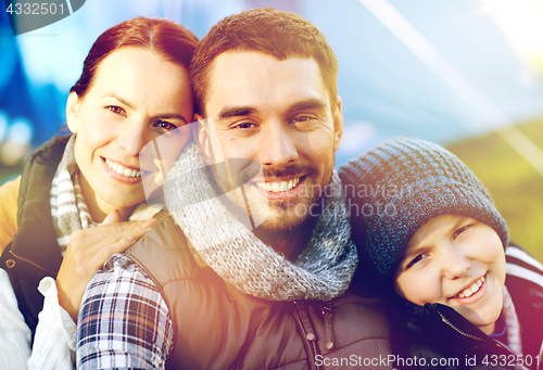 Image of happy family portrait over tent at camp site