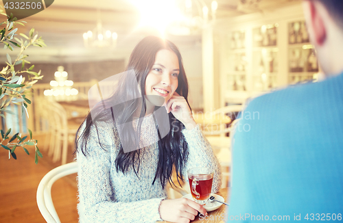 Image of happy couple drinking tea at cafe