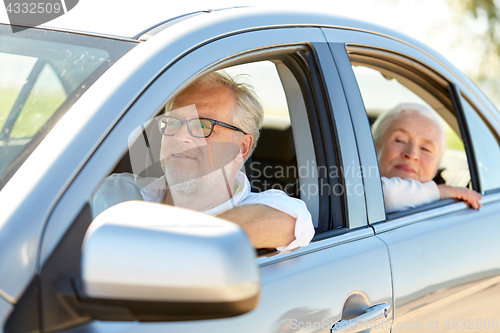 Image of happy senior couple driving in car