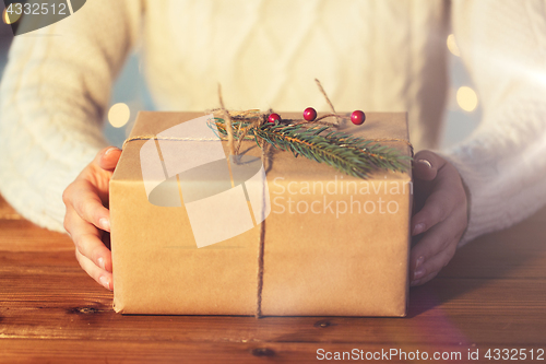 Image of close up of woman with christmas gift or parcel