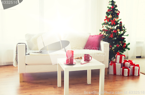 Image of living room interior with christmas tree and gifts