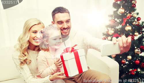 Image of family taking selfie with smartphone at christmas