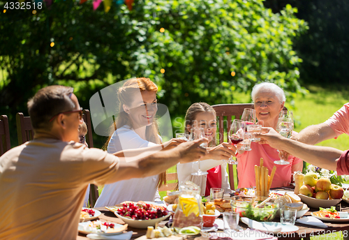 Image of happy family having dinner or summer garden party