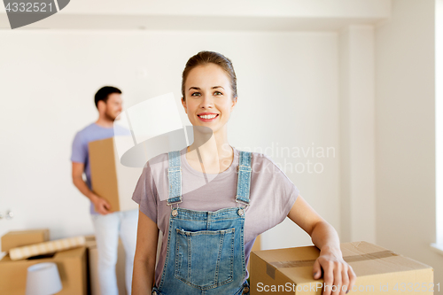 Image of happy couple with boxes moving to new home