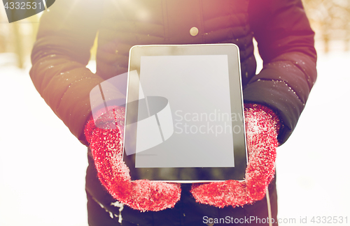 Image of close up of woman with tablet pc in winter