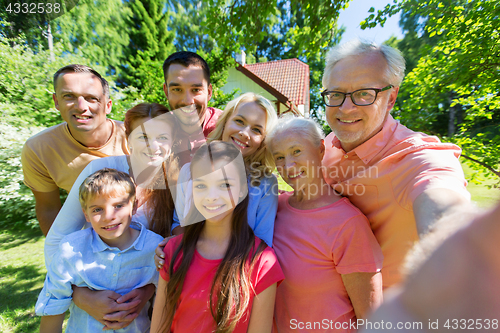 Image of happy family taking selfie in summer garden