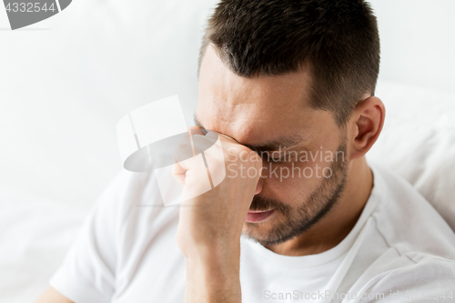 Image of close up of man in bed thinking