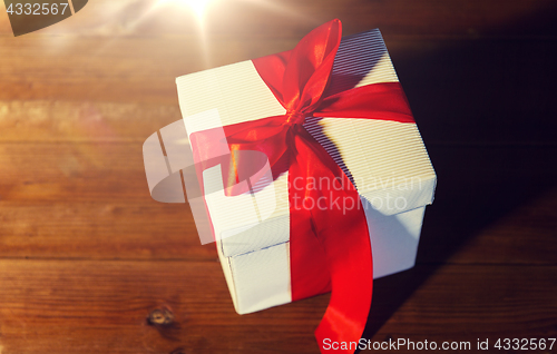 Image of close up of christmas  gift box on wooden floor