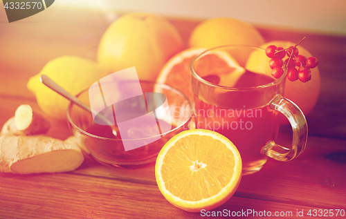 Image of tea with honey, lemon and ginger on wood