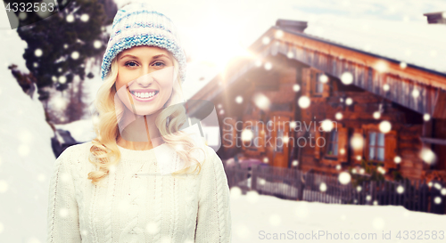 Image of smiling young woman in winter hat and sweater