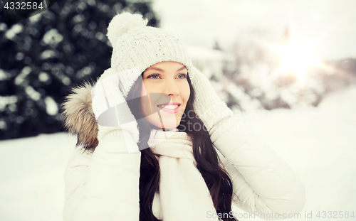 Image of happy woman outdoors in winter clothes