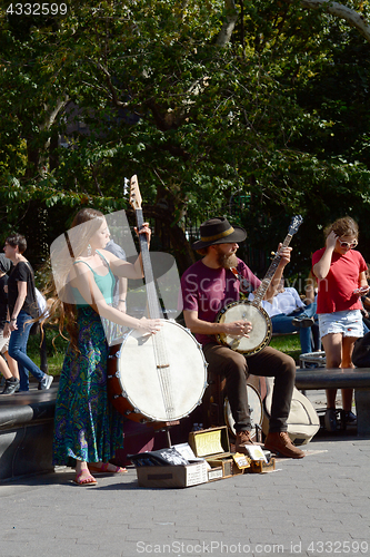 Image of Two street musicians playing for tourists in Washington Square P