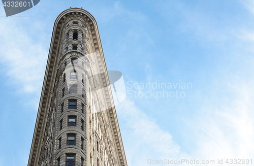 Image of Narrow end of the Flatiron Building against a blue sky