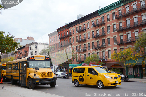 Image of Yellow school bus and NYC taxi cab