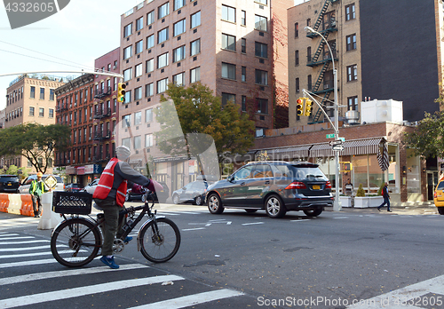 Image of Delivery cyclist waiting at red light in Hell\'s Kitchen