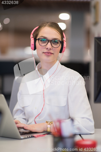 Image of businesswoman using a laptop in startup office