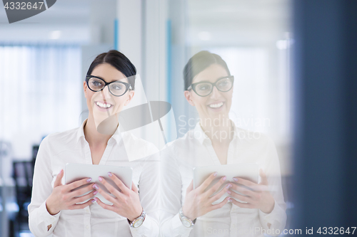 Image of Business Woman Using Digital Tablet in front of startup Office