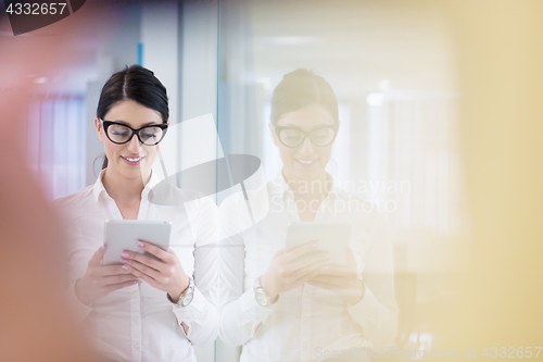 Image of Business Woman Using Digital Tablet in front of startup Office