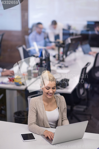 Image of businesswoman using a laptop in startup office