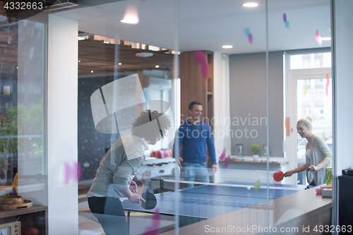 Image of startup business team playing ping pong tennis