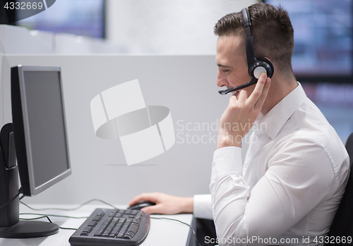 Image of male call centre operator doing his job