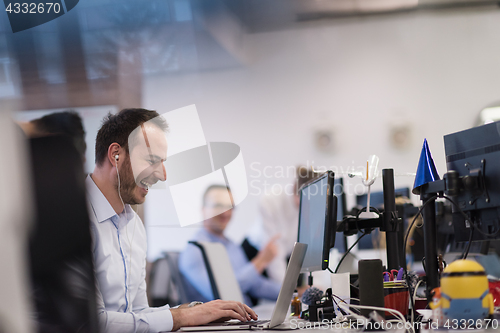 Image of businessman working using a laptop in startup office