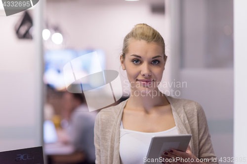 Image of Business Woman Using Digital Tablet in front of startup Office