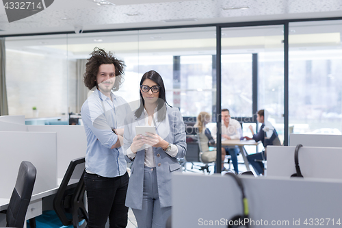 Image of Business People Working With Tablet in startup office