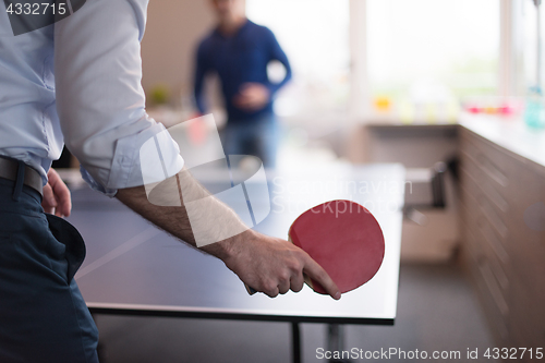 Image of startup business team playing ping pong tennis