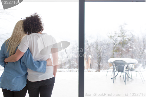 Image of young couple enjoying morning coffee by the window