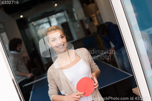 Image of startup business team playing ping pong tennis