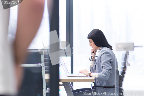 Image of businesswoman using a laptop in startup office