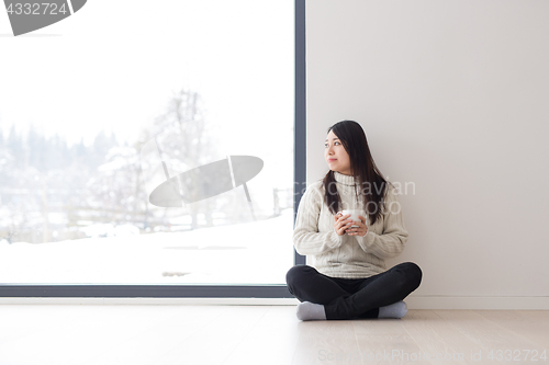 Image of asian woman enjoying morning coffee