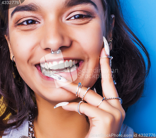 Image of lifestyle people concept. young pretty smiling indian girl with long nails wearing lot of jewelry rings, asian summer happy cool 