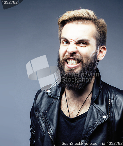 Image of portrait of young bearded hipster guy on gray dark background close up, brutal modern man, lifestyle people concept 
