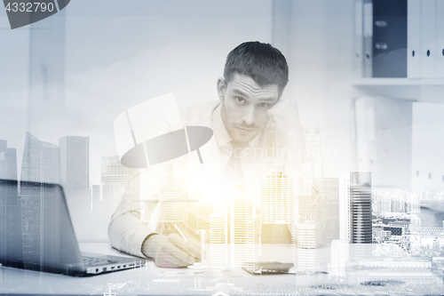 Image of stressed businessman with laptop at office