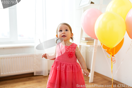 Image of happy baby girl on birthday party at home