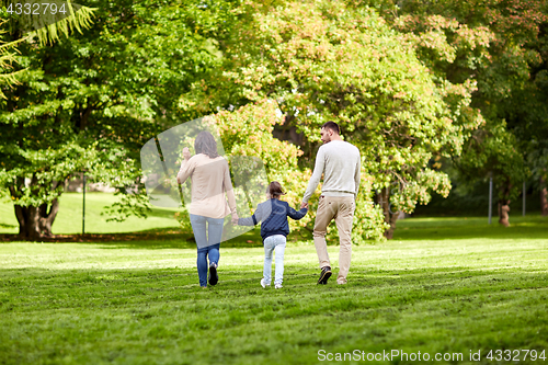 Image of happy family walking in summer park