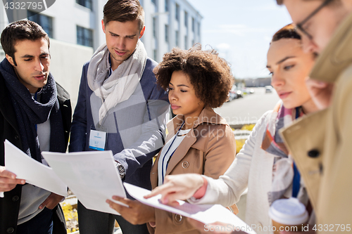 Image of international business team with papers in city