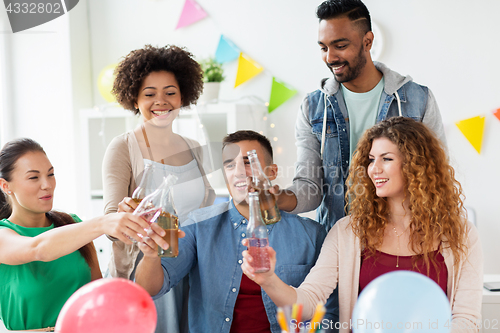 Image of happy team with drinks celebrating at office party