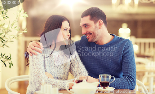 Image of happy couple drinking tea at restaurant