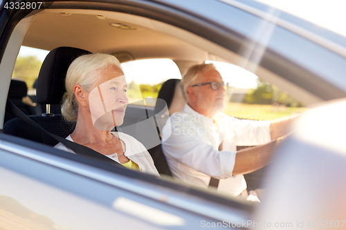 Image of happy senior couple driving in car