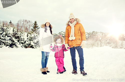 Image of happy family with child in winter clothes outdoors