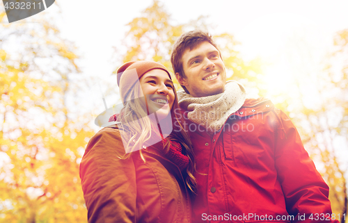 Image of happy young couple walking in autumn park