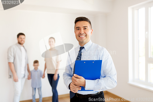 Image of realtor with clipboard and family at new home