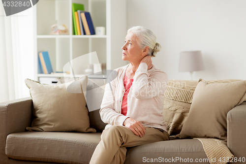 Image of senior woman suffering from neck pain at home