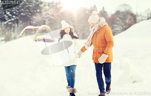 Image of happy couple walking over winter background