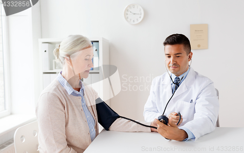 Image of senior woman and doctor with tonometer at hospital