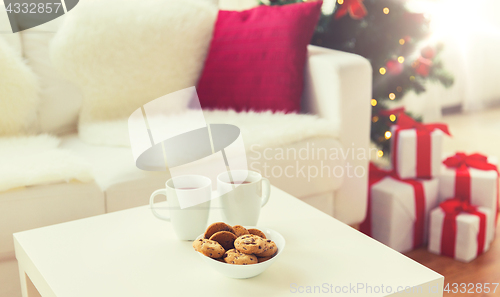 Image of close up of christmas cookies and cups on table